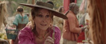 Movie still from “The Little Mermaid” (2023), directed by Rob Marshall – A woman in a straw hat holding a fork; Close Up shot, Over the shoulder angle