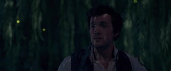 Movie still from “The Little Mermaid” (2023), directed by Rob Marshall – A man in a vest looking to his left; Close Up shot, Over the shoulder angle