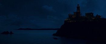 Movie still from “The Little Mermaid” (2023), directed by Rob Marshall – A night sky with a castle on the top of a cliff; Extreme Wide shot, Low angle