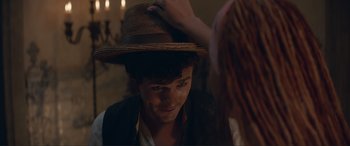 Movie still from “The Little Mermaid” (2023), directed by Rob Marshall – A young man wearing a cowboy hat while looking at a young woman; Close Up shot, Over the shoulder angle