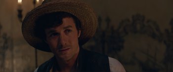 Movie still from “The Little Mermaid” (2023), directed by Rob Marshall – A person wearing a straw hat; Close Up shot, Over the shoulder angle