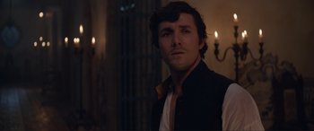 Movie still from “The Little Mermaid” (2023), directed by Rob Marshall – A person wearing a jacket; Close Up shot, Over the shoulder angle