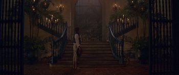 Movie still from “The Little Mermaid” (2023), directed by Rob Marshall – A man standing in front of a set of stairs; Wide shot, Low angle