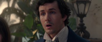 Movie still from “The Little Mermaid” (2023), directed by Rob Marshall – A person wearing a suit and tie; Close Up shot, High angle