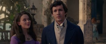 Movie still from “The Little Mermaid” (2023), directed by Rob Marshall – A man in a suit standing next to a woman in a dress; Close Up shot, Over the shoulder angle