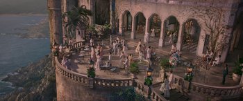 Movie still from “The Little Mermaid” (2023), directed by Rob Marshall – A group of people standing on top of a building; Extreme Wide shot, High angle