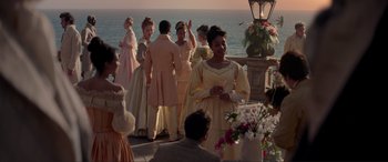 Movie still from “The Little Mermaid” (2023), directed by Rob Marshall – A group of people standing next to each other near the ocean; Wide shot, Over the shoulder angle