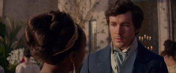 Movie still from “The Little Mermaid” (2023), directed by Rob Marshall – A man and a woman in formal wear looking at each other; Close Up shot, Over the shoulder angle