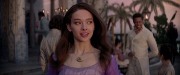 Movie still from “The Little Mermaid” (2023), directed by Rob Marshall – A beautiful young lady with long brown hair wearing a purple dress; Close Up shot, Over the shoulder angle
