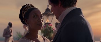 Movie still from “The Little Mermaid” (2023), directed by Rob Marshall – A man and a woman standing next to each other in front of a street light; Close Up shot, Over the shoulder angle