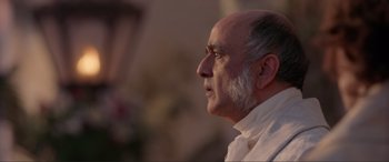Movie still from “The Little Mermaid” (2023), directed by Rob Marshall – An older man wearing a white shirt looking up; Close Up shot, Low angle