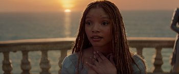 Movie still from “The Little Mermaid” (2023), directed by Rob Marshall – A woman with dreads is looking at the camera; Close Up shot, Over the shoulder angle