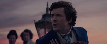 Movie still from “The Little Mermaid” (2023), directed by Rob Marshall – A person wearing a suit and tie; Close Up shot, Over the shoulder angle