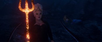Movie still from “The Little Mermaid” (2023), directed by Rob Marshall – An image of a woman in a black dress; Medium shot, Over the shoulder angle