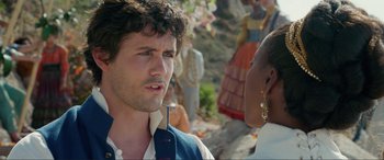 Movie still from “The Little Mermaid” (2023), directed by Rob Marshall – A man and a woman are standing in front of a crowd; Close Up shot, Over the shoulder angle