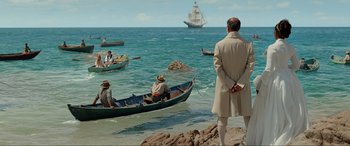 Movie still from “The Little Mermaid” (2023), directed by Rob Marshall – A group of people in a boat in the water; Extreme Wide shot, High angle