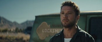 Movie still from “The Locksmith” (2023), directed by Nicolas Harvard – A person wearing a leather jacket; Close Up shot, Over the shoulder angle