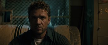 Movie still from “The Locksmith” (2023), directed by Nicolas Harvard – A person with curly hair; Close Up shot, Over the shoulder angle