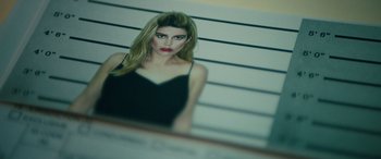 Movie still from “The Locksmith” (2023), directed by Nicolas Harvard – A picture of a woman in front of a wall; Extreme Close Up shot, Overhead angle