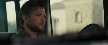 Movie still from “The Locksmith” (2023), directed by Nicolas Harvard – A person looking out a window; Close Up shot, Over the shoulder angle