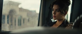 Movie still from “The Locksmith” (2023), directed by Nicolas Harvard – A woman sitting in a car looking out the window; Close Up shot, Over the shoulder angle