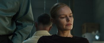 Movie still from “The Locksmith” (2023), directed by Nicolas Harvard – A man and a woman are standing next to each other; Close Up shot, Over the shoulder angle