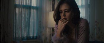 Movie still from “The Locksmith” (2023), directed by Nicolas Harvard – A woman sitting in front of a window with her hand on her chin; Close Up shot, Low angle