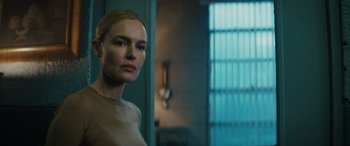 Movie still from “The Locksmith” (2023), directed by Nicolas Harvard – A woman standing in front of a bathroom mirror; Close Up shot, Over the shoulder angle