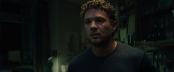 Movie still from “The Locksmith” (2023), directed by Nicolas Harvard – A person with curly hair; Close Up shot, Over the shoulder angle