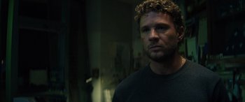 Movie still from “The Locksmith” (2023), directed by Nicolas Harvard – A person with curly hair; Close Up shot, Low angle