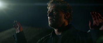 Movie still from “The Locksmith” (2023), directed by Nicolas Harvard – A person looking up at the sky; Close Up shot, Low angle