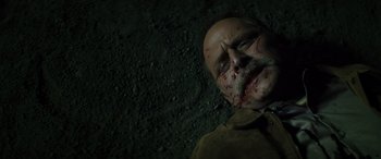 Movie still from “The Locksmith” (2023), directed by Nicolas Harvard – A man with blood all over his face; Close Up shot, Overhead angle