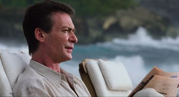 Movie still from “The Lost World: Jurassic Park” (1997), directed by Steven Spielberg – A person sitting in a chair near a body of water; Close Up shot, Low angle