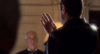 Movie still from “The Lost World: Jurassic Park” (1997), directed by Steven Spielberg – A man in a black jacket is talking to another man in a black suit; Close Up shot, Over the shoulder angle