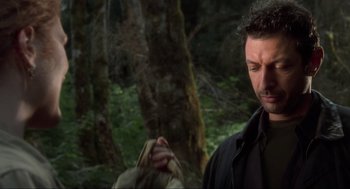 Movie still from “The Lost World: Jurassic Park” (1997), directed by Steven Spielberg – A man standing in front of some trees; Close Up shot, Over the shoulder angle