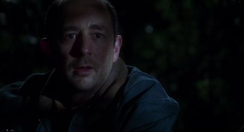 Movie still from “The Lost World: Jurassic Park” (1997), directed by Steven Spielberg – A person in a dark room; Close Up shot, Over the shoulder angle