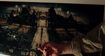 Movie still from “The Lost World: Jurassic Park” (1997), directed by Steven Spielberg – A man's hand is on a painting of a city; Extreme Close Up shot, High angle