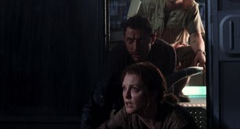 A man and a woman sitting next to each other in the dark