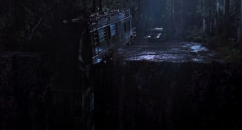 Movie still from “The Lost World: Jurassic Park” (1997), directed by Steven Spielberg – A bus parked on top of a cliff in the dark; Extreme Wide shot, High angle
