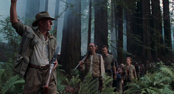 Movie still from “The Lost World: Jurassic Park” (1997), directed by Steven Spielberg – A group of people walking through a forest; Wide shot, Low angle