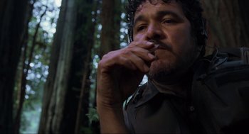 Movie still from “The Lost World: Jurassic Park” (1997), directed by Steven Spielberg – A person smoking a cigarette in the woods; Close Up shot, Low angle