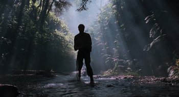 Movie still from “The Lost World: Jurassic Park” (1997), directed by Steven Spielberg – A man standing in the middle of a forest; Extreme Wide shot, Low angle