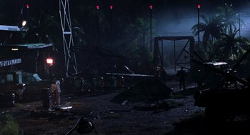 Movie still from “The Lost World: Jurassic Park” (1997), directed by Steven Spielberg – A group of people standing in the middle of a field; Extreme Wide shot, High angle