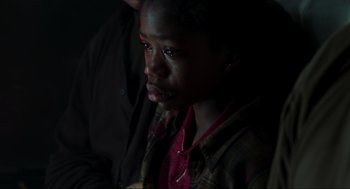 Movie still from “The Lost World: Jurassic Park” (1997), directed by Steven Spielberg – A young boy with a bruised face sitting in a dark room; Close Up shot, High angle