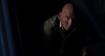 Movie still from “The Lost World: Jurassic Park” (1997), directed by Steven Spielberg – A man with bald head is looking at the camera; Close Up shot, Low angle