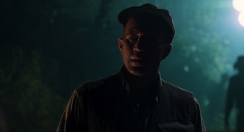 Movie still from “The Lost World: Jurassic Park” (1997), directed by Steven Spielberg – A man wearing a hat standing in the dark; Close Up shot, Low angle