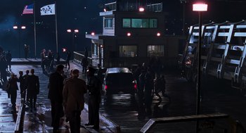 Movie still from “The Lost World: Jurassic Park” (1997), directed by Steven Spielberg – A group of people standing on the side of a road at night; Extreme Wide shot, High angle