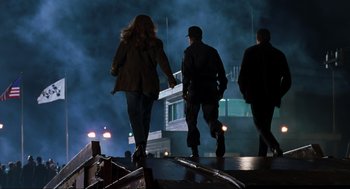 Movie still from “The Lost World: Jurassic Park” (1997), directed by Steven Spielberg – A group of people walking across a bridge at night; Wide shot, Low angle