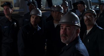 Movie still from “The Lost World: Jurassic Park” (1997), directed by Steven Spielberg – A group of men wearing hard hats in the dark; Close Up shot, Low angle