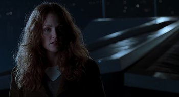 Movie still from “The Lost World: Jurassic Park” (1997), directed by Steven Spielberg – A woman with long red hair standing in the dark; Close Up shot, Low angle